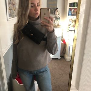 Black fanny pack faux leather buckles in the back